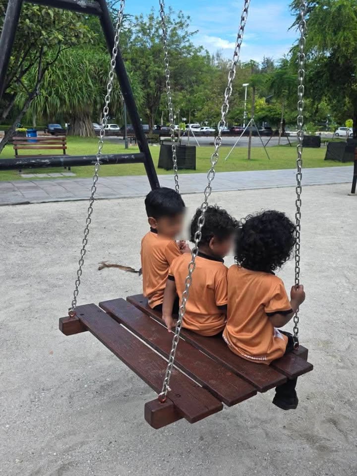 Little ones create joyful memories swinging together at the park
